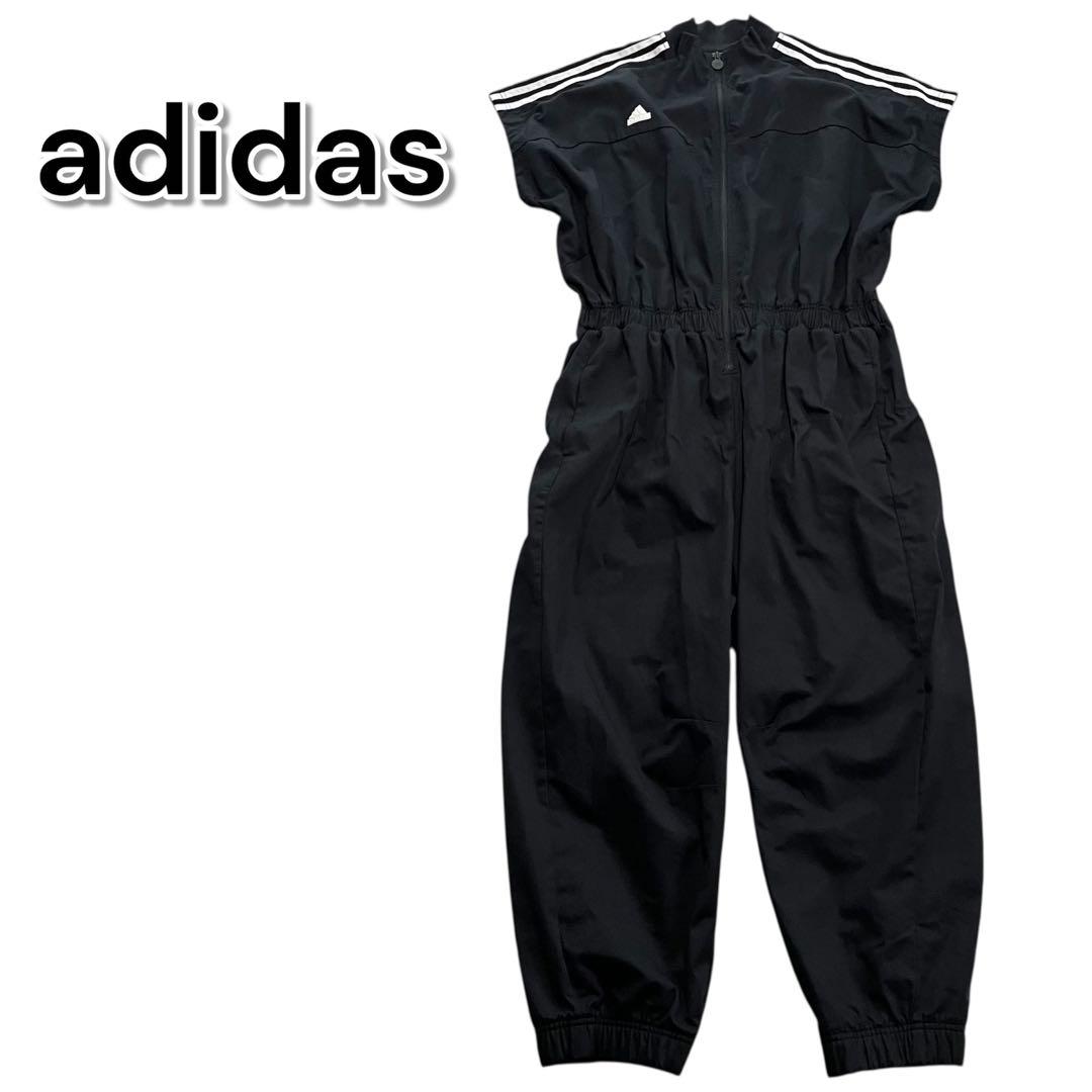 アディダス ジャンプスーツ 半袖 ブラック 黒 ロゴ オールインワン つなぎ adidas（アディダス）の「Always Original スナップボタン ジャンプ