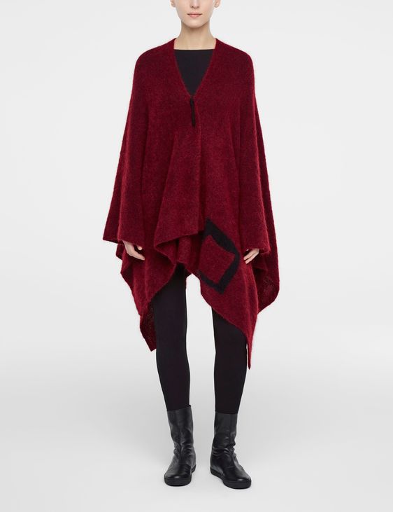 Red mohair poncho by Sarah Pacini